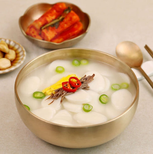 korean new year tteokguk rice cake soup with essential kitchen tools