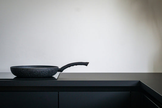Nonstick frying pan on a modern kitchen countertop, representing everyday cookware use